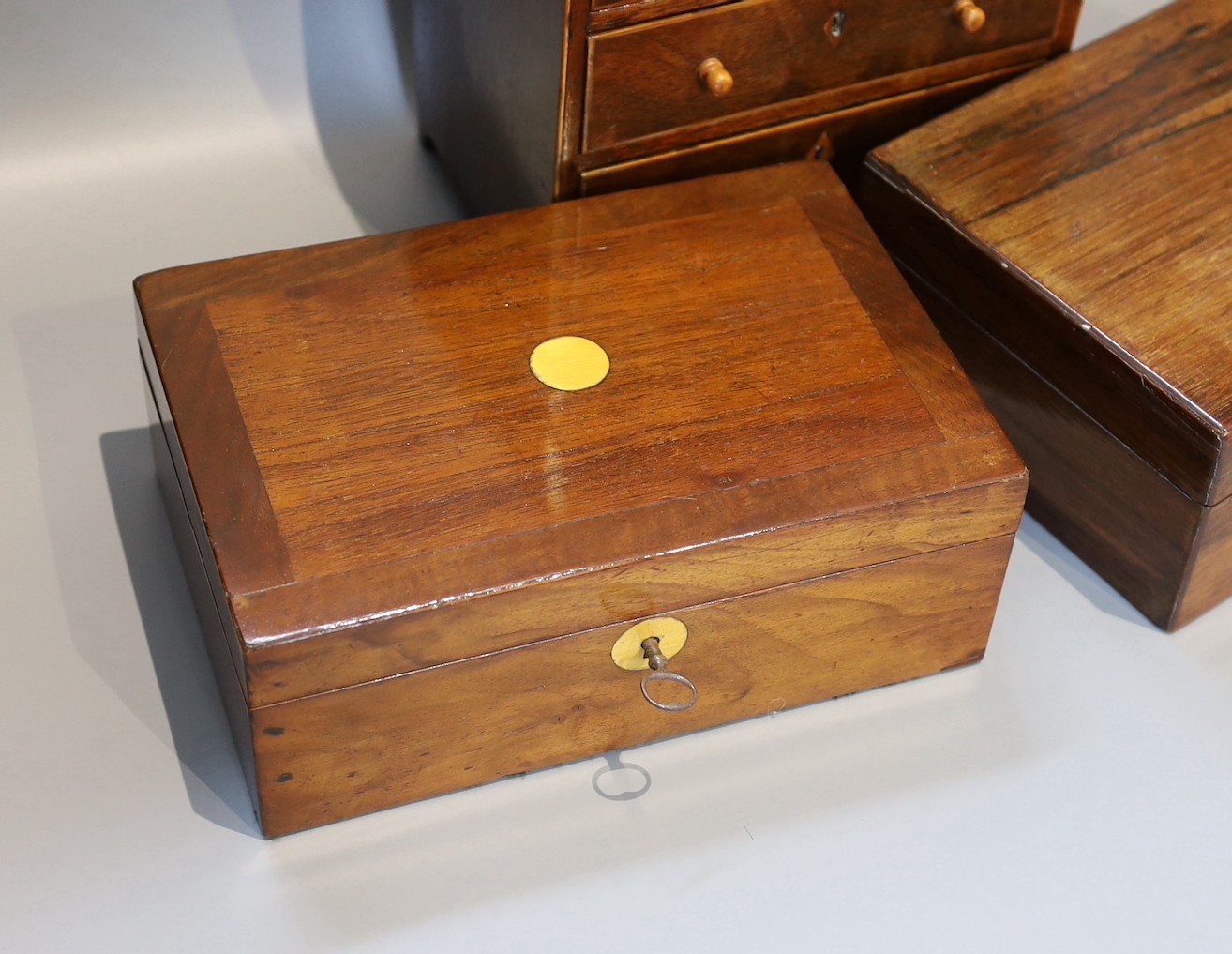 A Victorian rosewood jewellery casket, one other and a 19th century mahogany apprentice chest, height 25cm